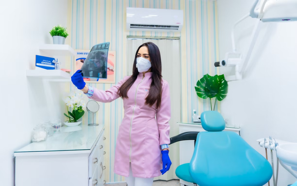 a dentist examining a dental x-ray inside a dental clinic