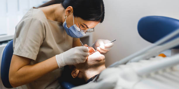 a dental professional performing a dental check-up on a patient